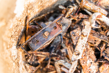 Diverse old rusty scrap metal from small items close-up