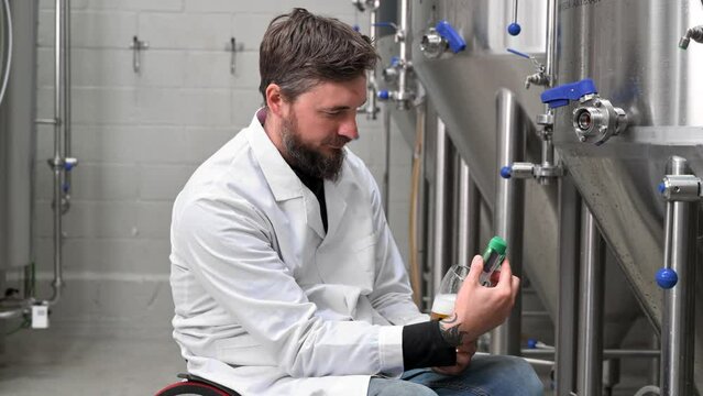 Brewer measuring pH in beer with digital meter. High quality 4k footage
