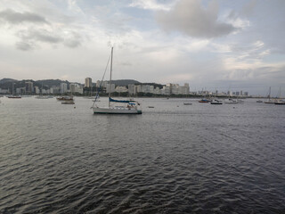 Fototapeta premium horizon landscape mountain forest stone sea beach sky cloud dawn city building sun low sun sunrise paradise life rest calm beautiful beauty short wall rower boat canoe Cristo Corcovado Rio de Janeiro 