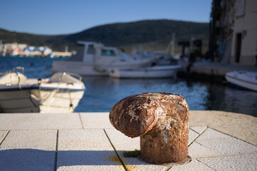 Rusty bollard in the harbour of Cres - obrazy, fototapety, plakaty