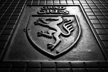 Coat of arms of the city of Cres on a sewer cover