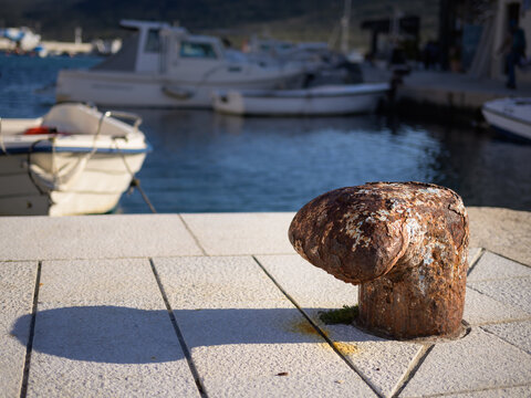Rusty bollard in the harbour of Cres