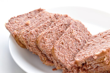 Fototapeta na wymiar Canned corned beef slices on a white plate.