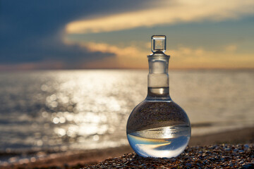 Glass flask by the sea.