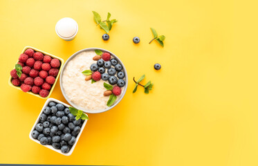Dietary breakfast with delicious oatmeal and fresh berries for a healthy diet of children, athletes. Top view of morning food