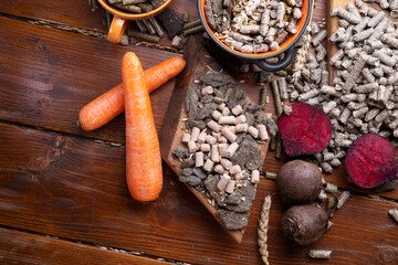 sunflower cake flakes,   grass, beetroot  and bran granules and cereals, fresh beetroots and carrats  for horses and other domestic animalsl. food concept. flat lay