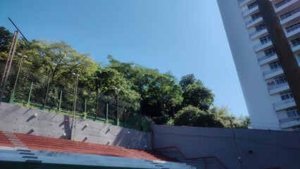 park garden tree bush forest leaf blue sky cloud court soccer hall building skyline horizon ladder ladder court sport path cement construction grid motorcycle wall texture floor