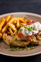 typical czech cuisine chicken slice baked with ham and camembert with french fries