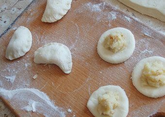 Cooking dumplings stuffed with yeast dough. Making traditional dumplings
