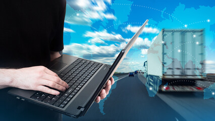 Truck business. Truck driver tracking via internet. Logistician with laptop. Concept truck dispatcher business. Lorry is driving down road. Silhouettes of continents in front of road.