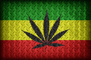 Rasta flag pattern with a marijuana leaf on diamond metal plate texture ,vintage style