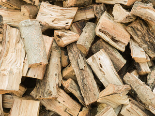 Heap firewood stack background. Natural wood.