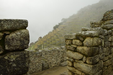 Ruins of the ancient Inca city machu picchu in fog, Peru