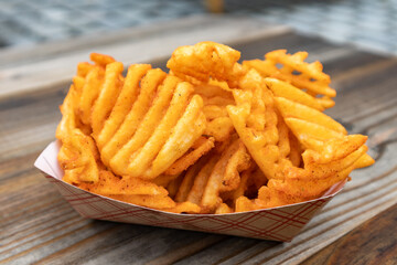 Waffle Fries in a Disposable Container on a Table