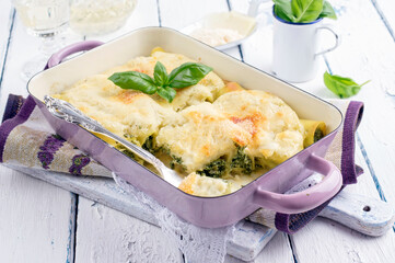 Traditional Italian cannelloni ricotta e spinaci served as close-up in a roasting tin