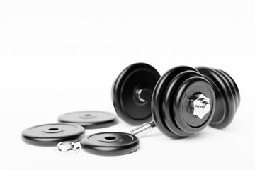 Obraz na płótnie Canvas 3D illustration metal black dumbbell with disks on white background. Fitness and sports equipment