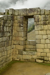 Ruins of the ancient Inca city machu picchu in fog, Peru