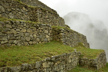 Ruins of the ancient Inca city machu picchu in fog, Peru