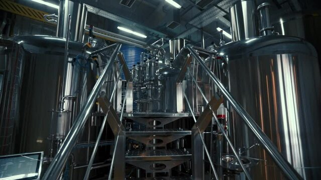 Large steel tanks with beer in industrial brewery plant. Stainless steel tanks for brewing beer. automated process. Modern Beer Factory.