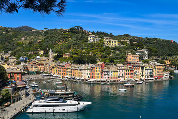 Fototapeta na wymiar Elevated view of the historic fishing village and popular holiday resort on the shore of the Tigullio Gulf, Portofino, Genoa, Liguria, Italy