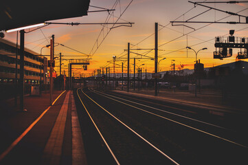 Fototapeta na wymiar romantic view of railways by the train station on the sunset