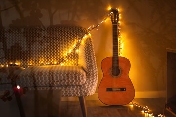 guitar decorated with garland in cozy warm toned interior