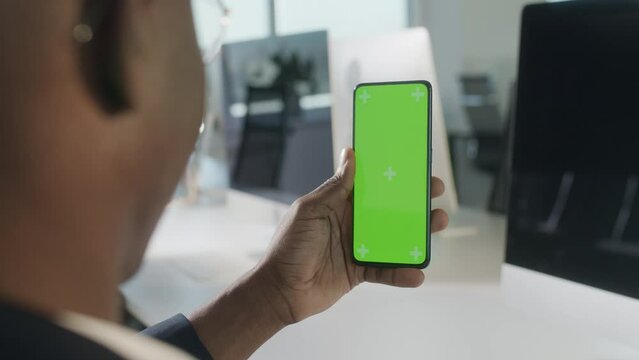 Without touching. Green Screen and Chroma Key of Smartphone. Businessman Using Smart Phone for Work. Office Worker Connects to Chat or Video Conference. Greenscreen of Chromakey Mock-Up