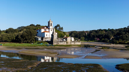 the Parish Church of our Lady of Sorrows in Barro on the Barro River at low tide