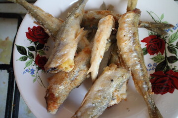 fried fish in a plate on the table