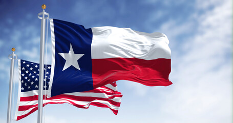 The Texas state flag waving along with the national flag of the United States of America - 504225683