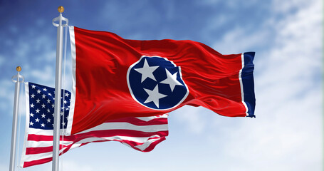 The Tennessee state flag waving along with the national flag of the United States of America