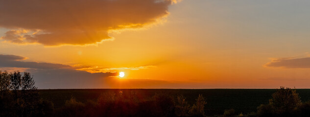 Obraz premium Sunrise or sunset on the river. Reflection of the sky and clouds in the river water