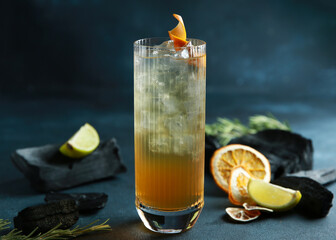 Drinks and cocktails. Orange cocktail with ice, citrus and orange twist on a bright gray...