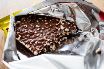 Dark chocolate with rice in open package, selective focus