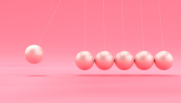 pink newton cradle in motion.
