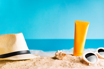 Sunscreen lotion on sandy beach