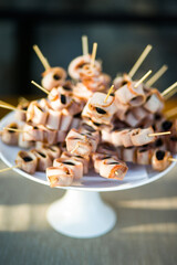Delicious canapes on the white plate, close-up