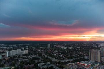 Fototapeta na wymiar Beautiful colorful sunset above city residential district, aerial view. 23 serpnia, Pavlovo Pole, Kharkiv, Ukraine. Majestic evening cloudscape and streets