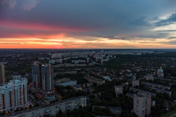 Naklejka na ściany i meble Epic vibrant sunset aerial view in city residential multistory district. Pavlovo Pole, Kharkiv Ukraine. Evening cloudscape and houses