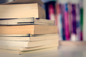 stacked books on table and blur background
