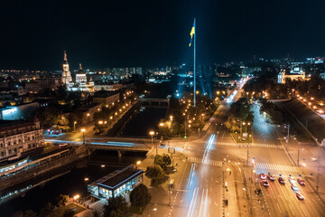 Fototapeta na wymiar Illuminated flag of Ukraine and Holy Annunciation Cathedral on river Lopan at night. Kharkiv city aerial, Ukraine in long exposure