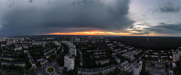 Epic sunset aerial urban panorama view in city residential district. 23 serpnia, Pavlovo Pole, Kharkiv, Ukraine. Majestic evening skyscape, cloudscape and streets