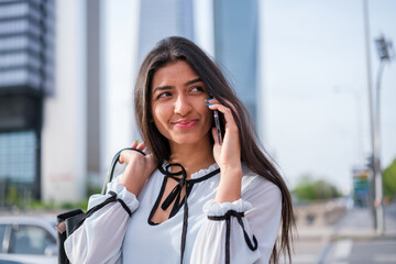 Empowered young woman managing the company by phone