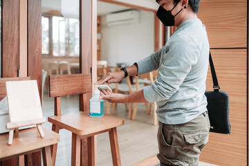 New normal life before going to cafes, restaurants, use alcohol to wash your hands.