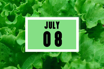 calendar date oncalendar date on the background of green lettuce leaves. July 8 is the eighth day of the month