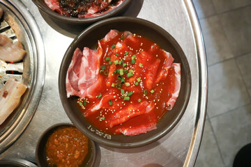 raw pork or sliced pork and raw beef with sauce