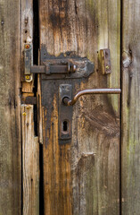 close-up of beautiful nostalgic locks on a barn door made of rustic wood