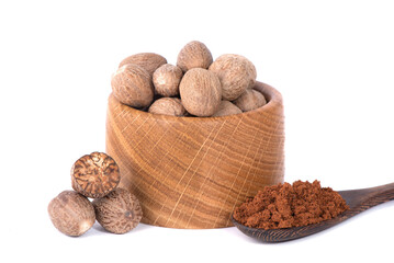 Nutmeg isolated on white background. Nutmeg powder. Nutmeg spice in a wooden spoon.