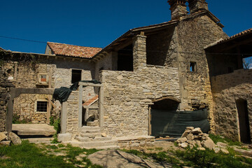 Fototapeta na wymiar Old residential buildings undergoing restoration work in the historic little medieval village of Kotli near Buzet in Istria, western Croatia 