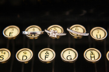Three wedding rings on a typewriter